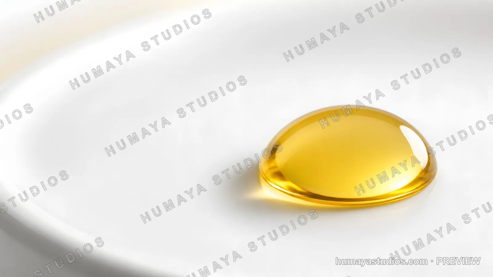 Golden liquid droplet on white ceramic surface