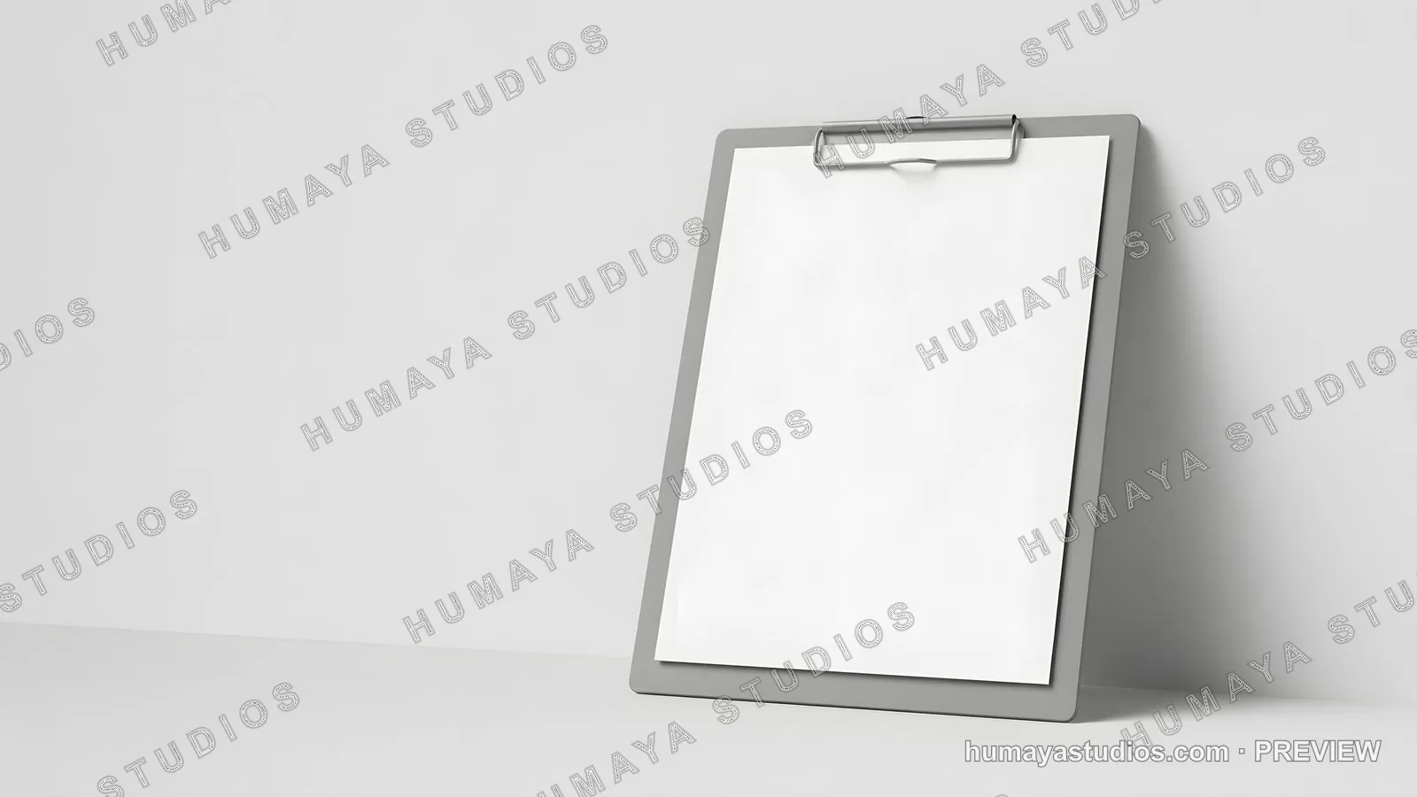 Vertical gray clipboard with blank white paper leaning against wall