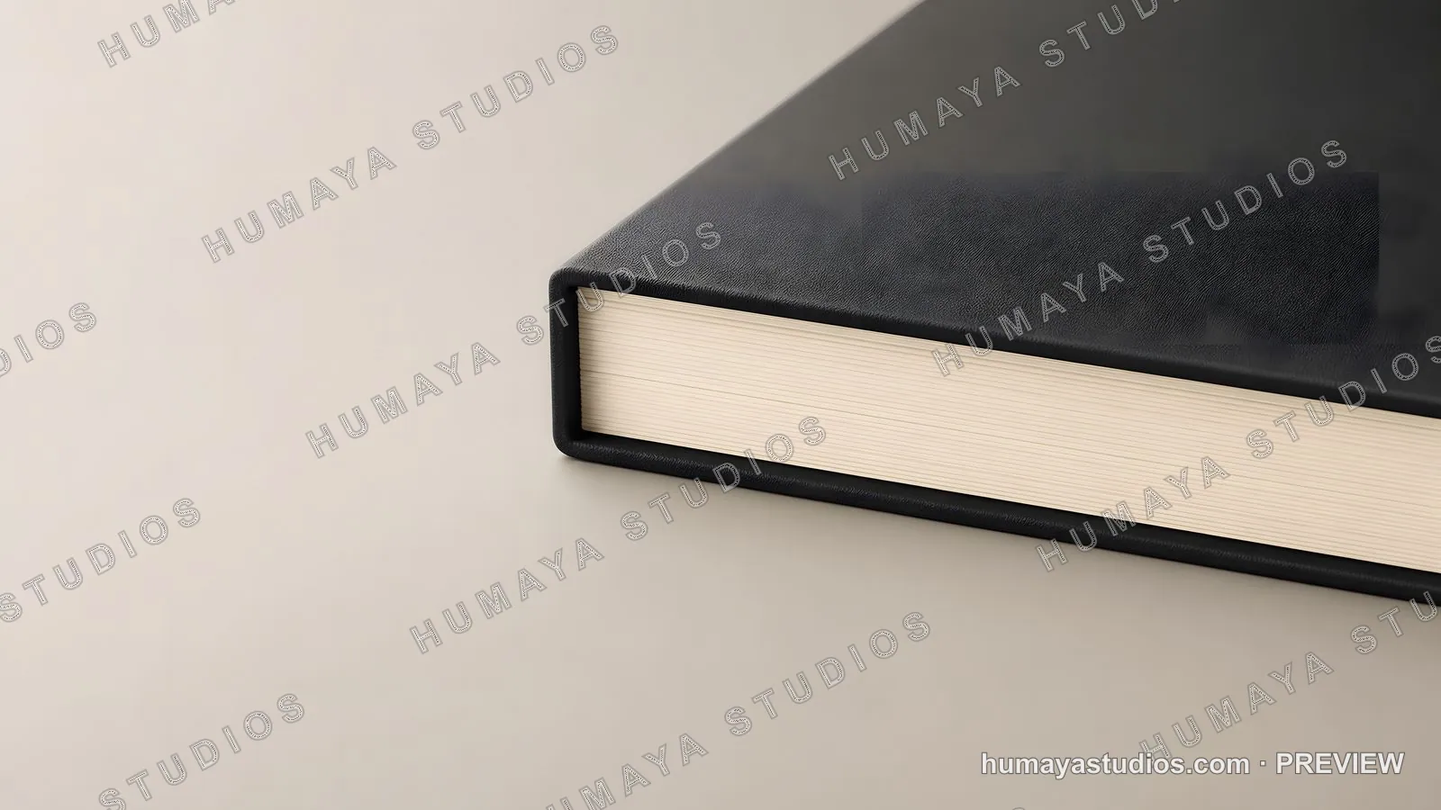 Black leather-bound book on a neutral surface