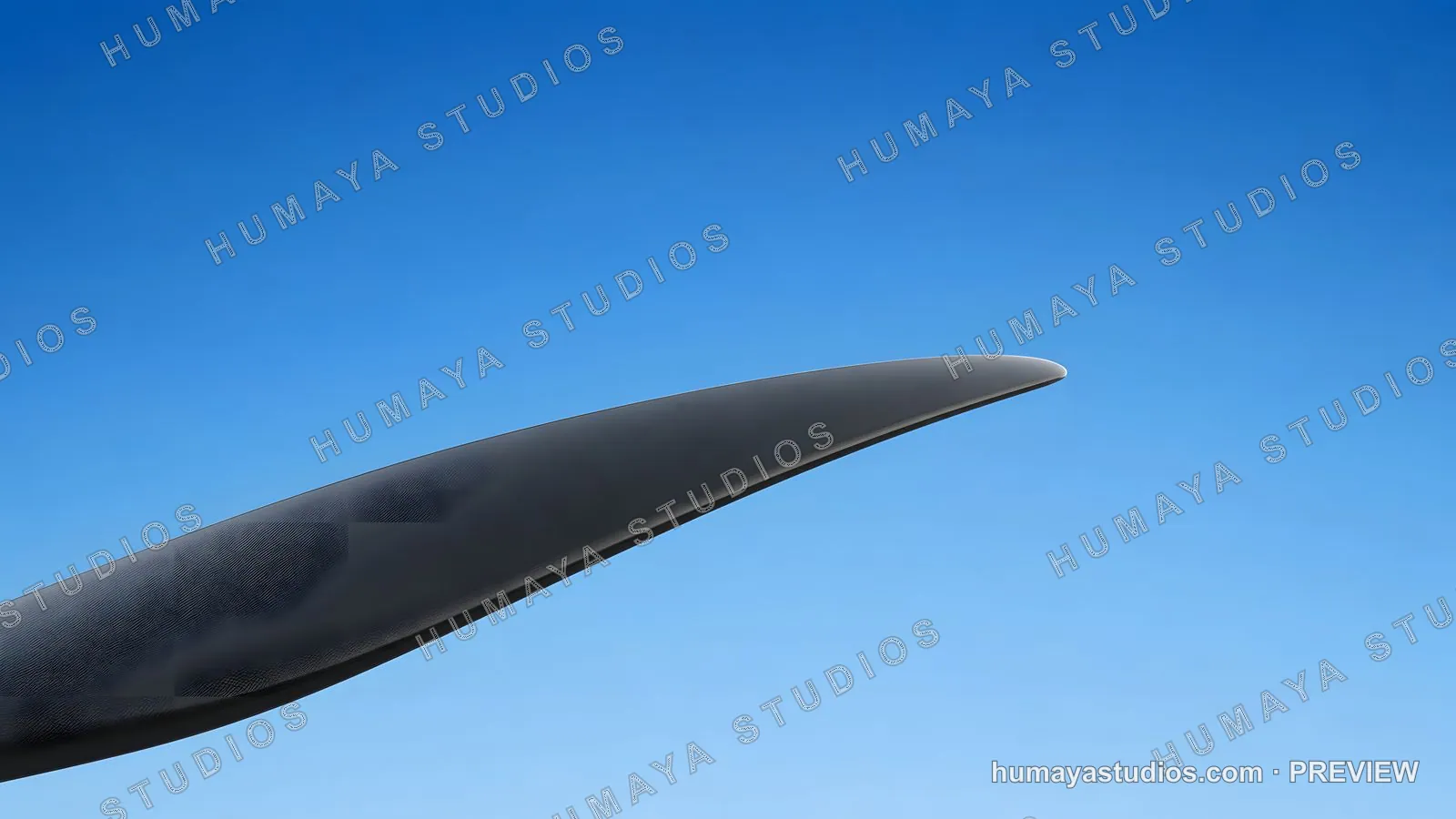Close-up of a carbon fiber airplane propeller blade against clear blue sky