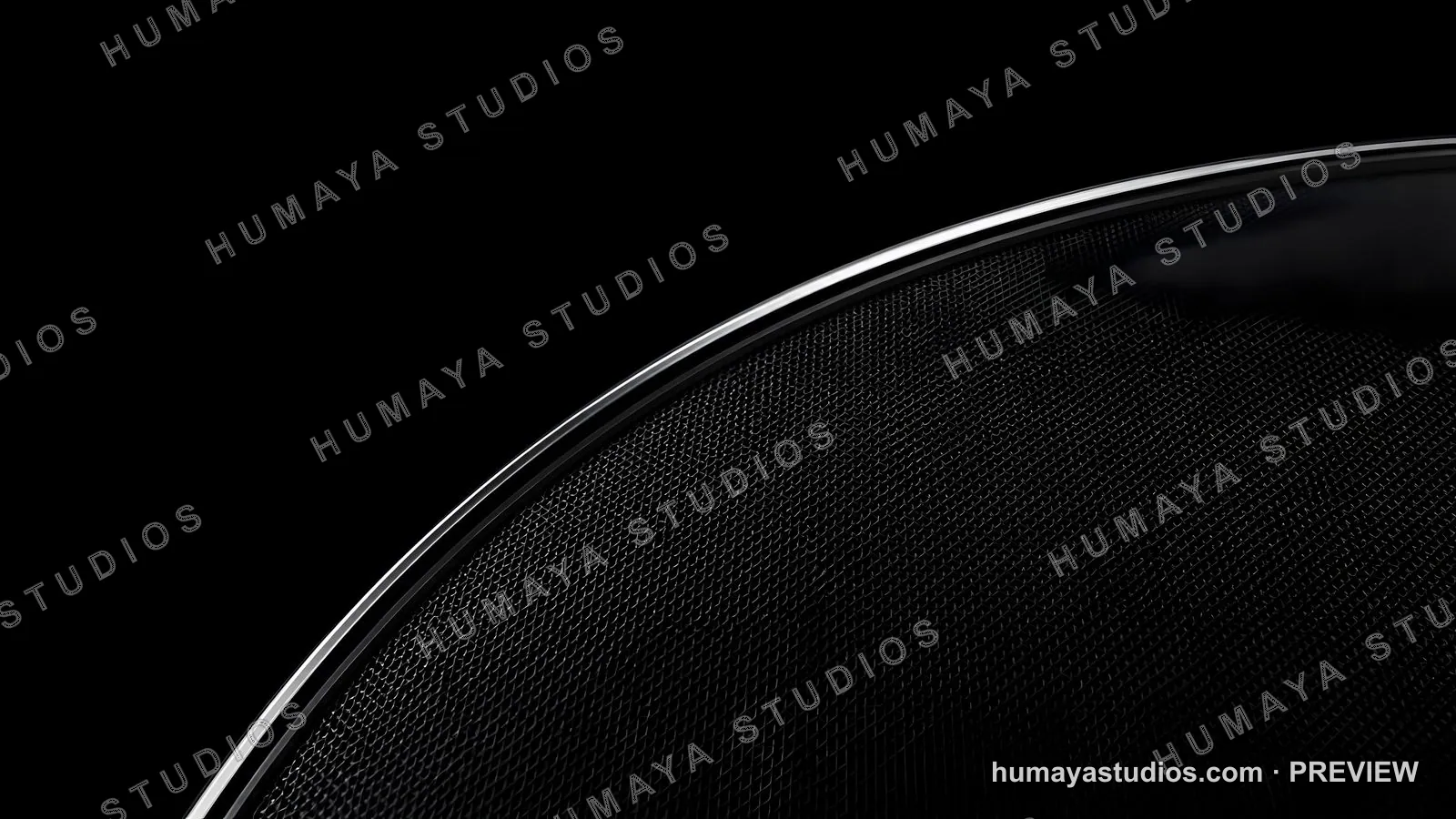 Close-up of a Modern Black Speaker Grill with Metallic Rim