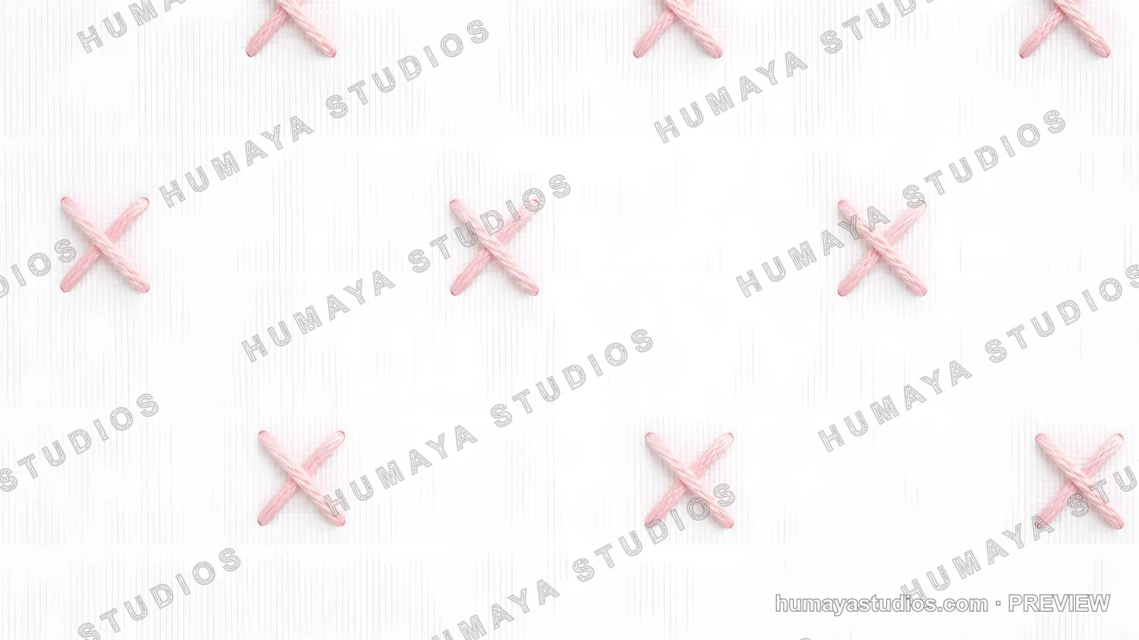 Pink cross-stitch embroidery pattern on white fabric texture