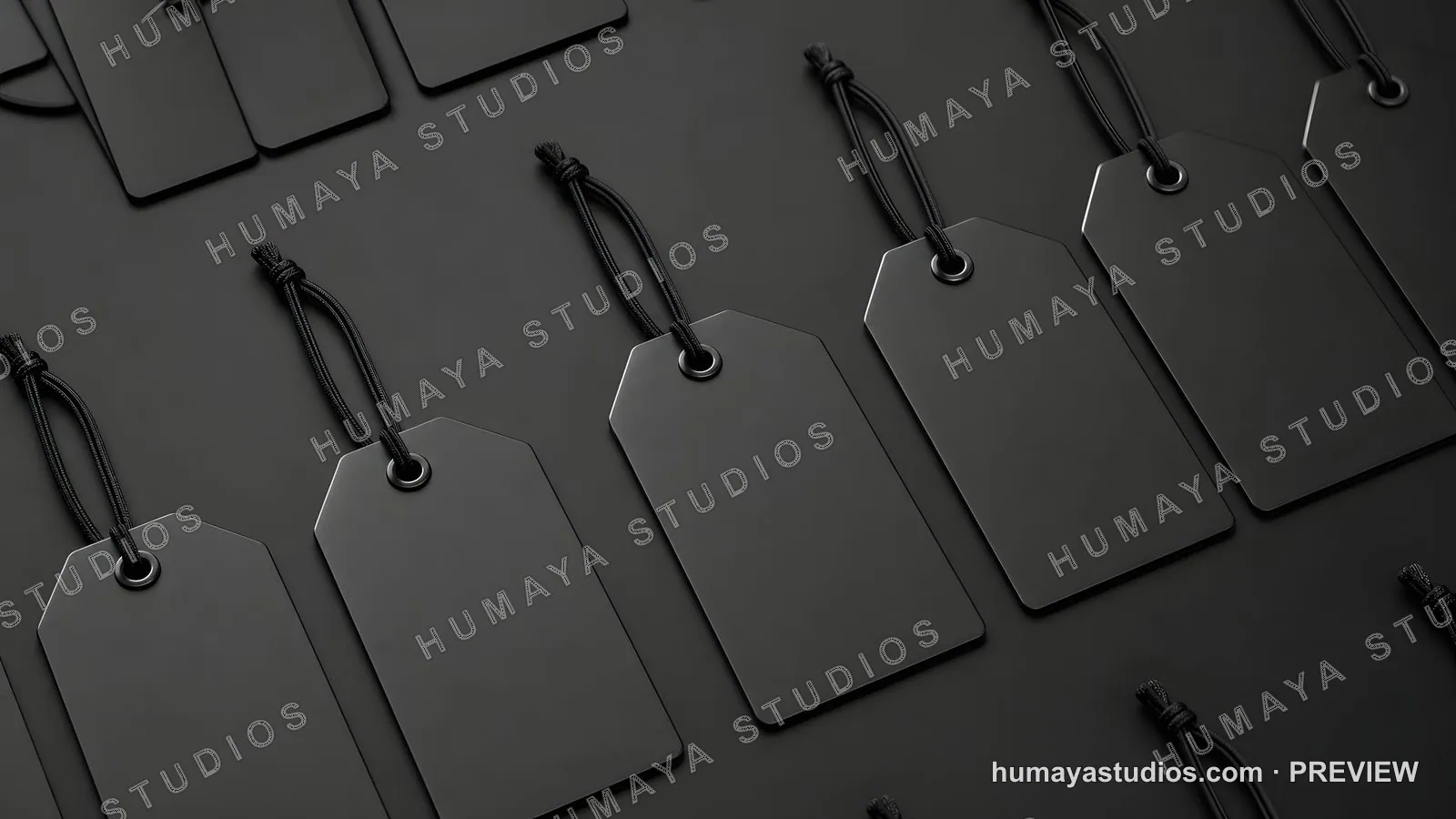Black price tags with strings on dark background