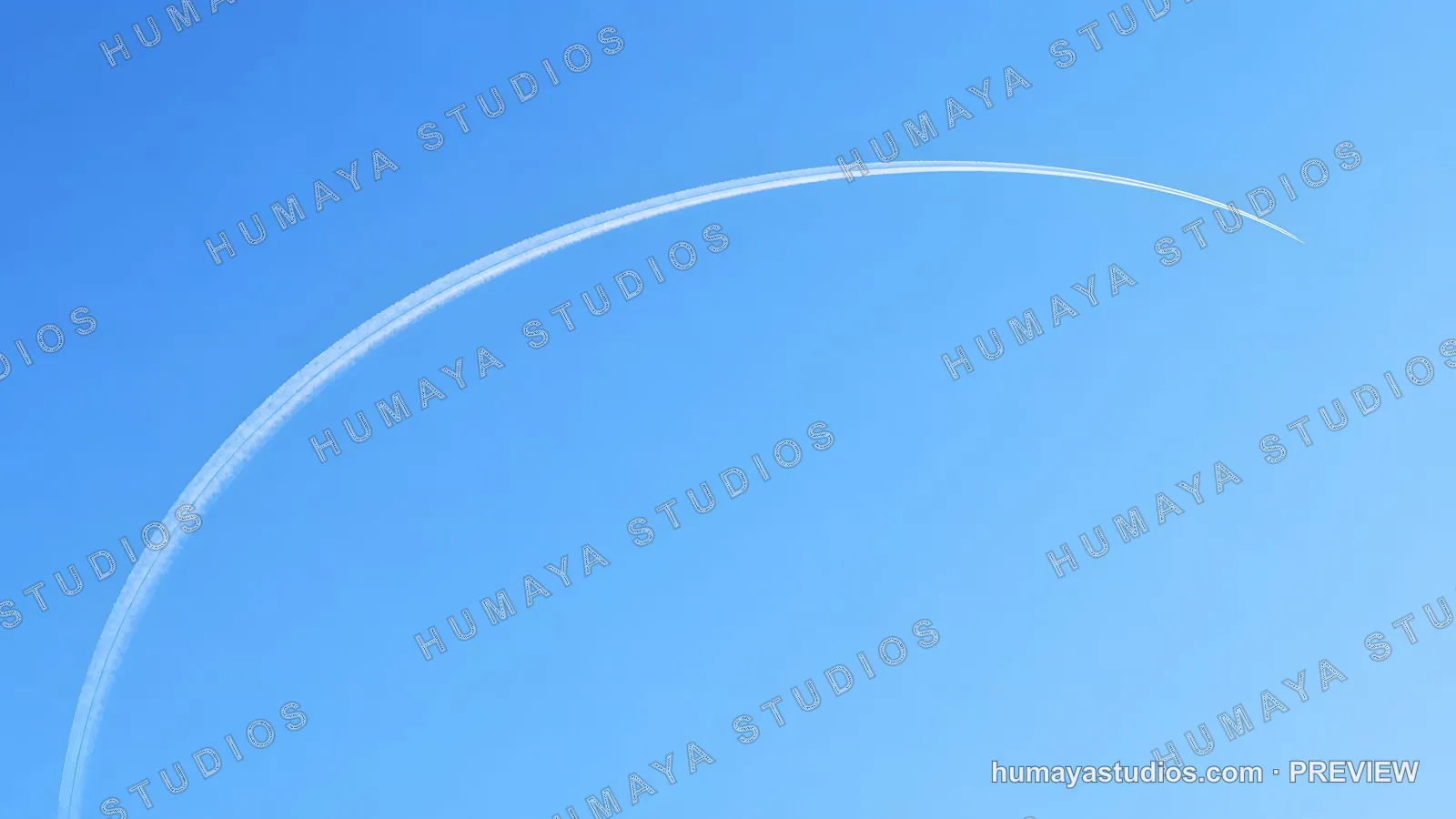 Curved Airplane Contrail Across Clear Blue Sky