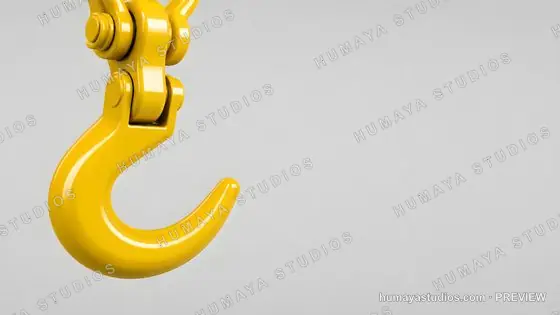 Yellow crane hook on grey background for heavy lifting