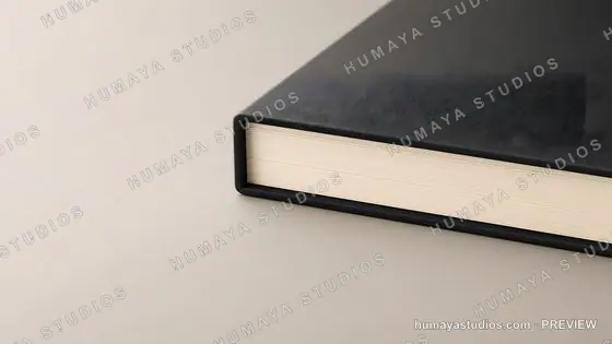 Black leather-bound book on a neutral surface