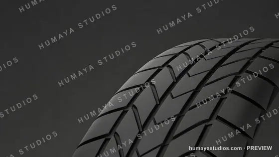 Close up of a black rubber car tire tread against dark background