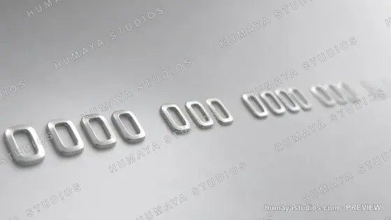 Close-up of embossed credit card numbers on a metallic surface