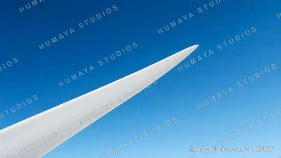 Wind turbine blade pointing up against clear blue sky background