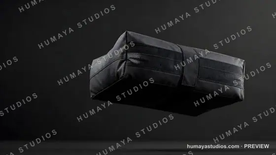 Black packing cube floating against dark background