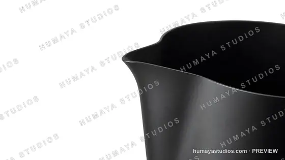 Close-up of a black milk frothing pitcher spout isolated on white