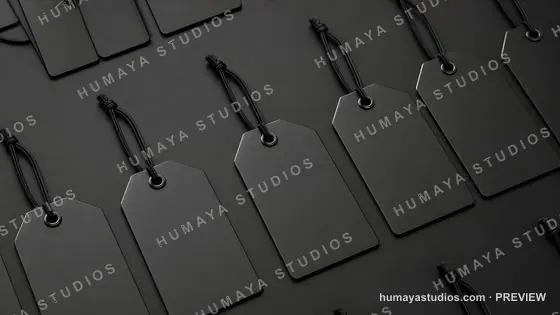 Black price tags with strings on dark background