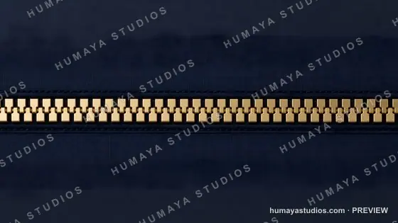 Macro Close-Up of Gold Zipper on Dark Blue Fabric