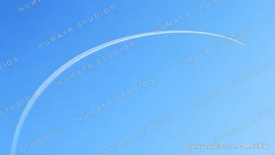 Curved Airplane Contrail Across Clear Blue Sky