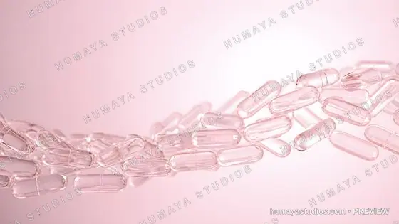Transparent medical capsules floating in a wave formation on pink