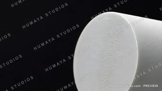 Porous White Ceramic Cylinder Close-up on Black Background
